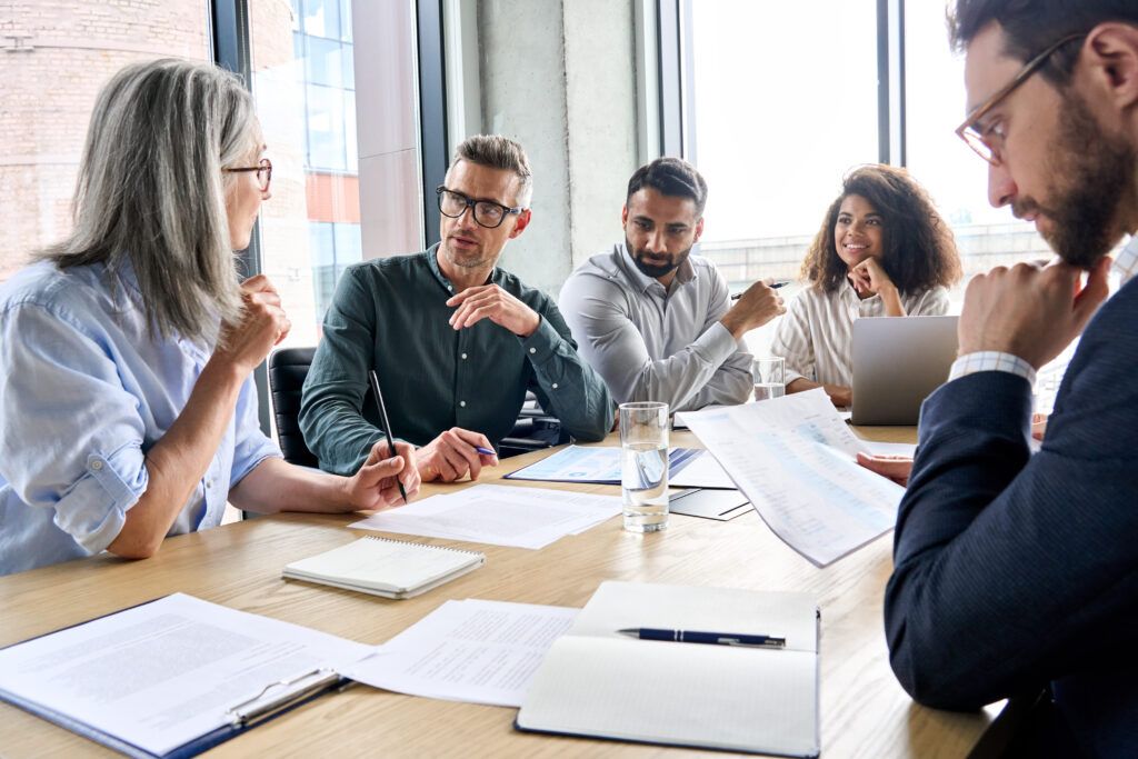 diverse group of professionals engaged in conversation at conference table