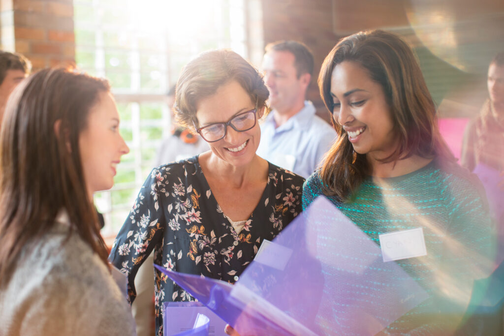 Group of women happily mingling in meeting room
