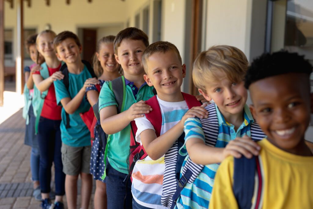 groups of elementary students lining up to enter classroom