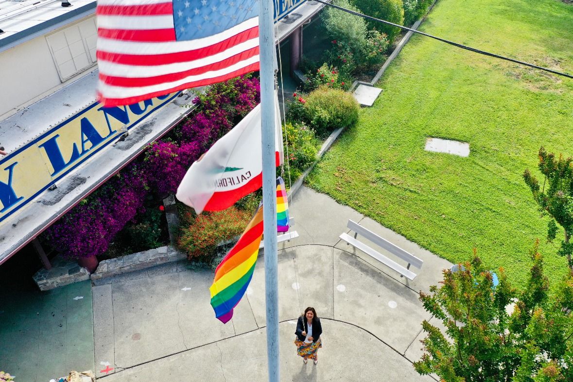 woman raising flag on school campus|Napa Valley USD|Napa Valley USD|Napa Valley Case Study